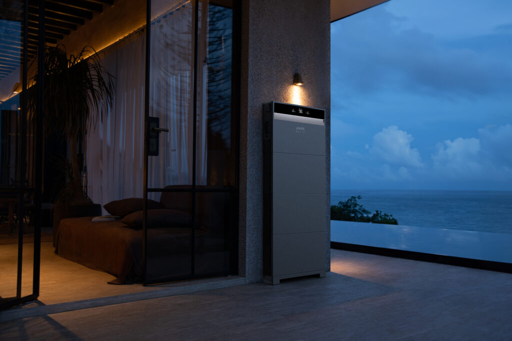 Anker Solix X1 installed outside in a coastal town with view of the ocean.