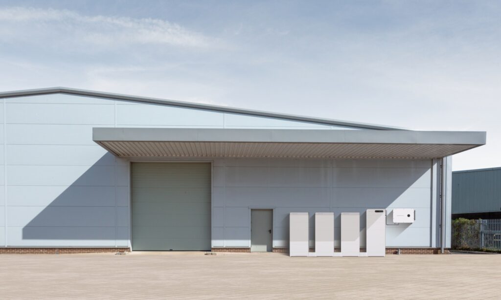 Industrial warehouse with SigenStack commercial battery system installed outdoors for large-scale energy storage and power management