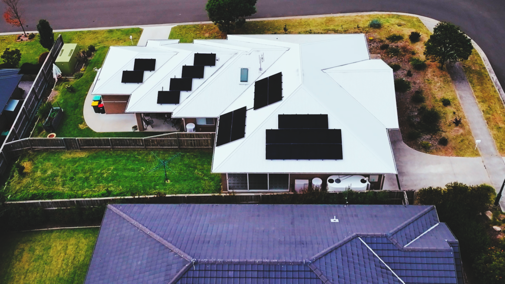 Aerial view of Kim's Southern Highlands home with rooftop solar panels that power his home solar and battery storage and EV charging setup.
