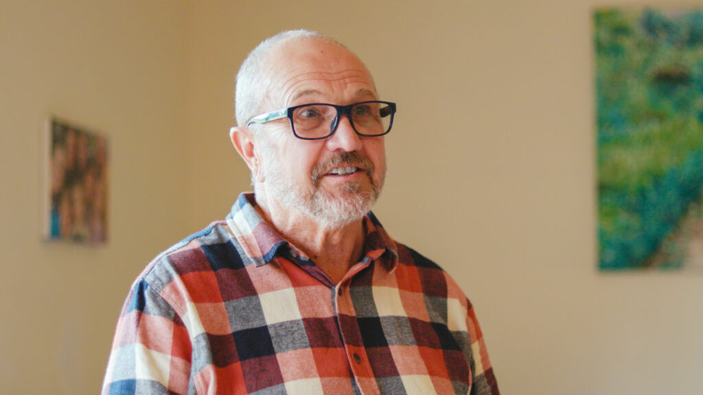 Peter smiles during a home interview, sharing how solar helped reduce his electricity bills and save on energy costs.