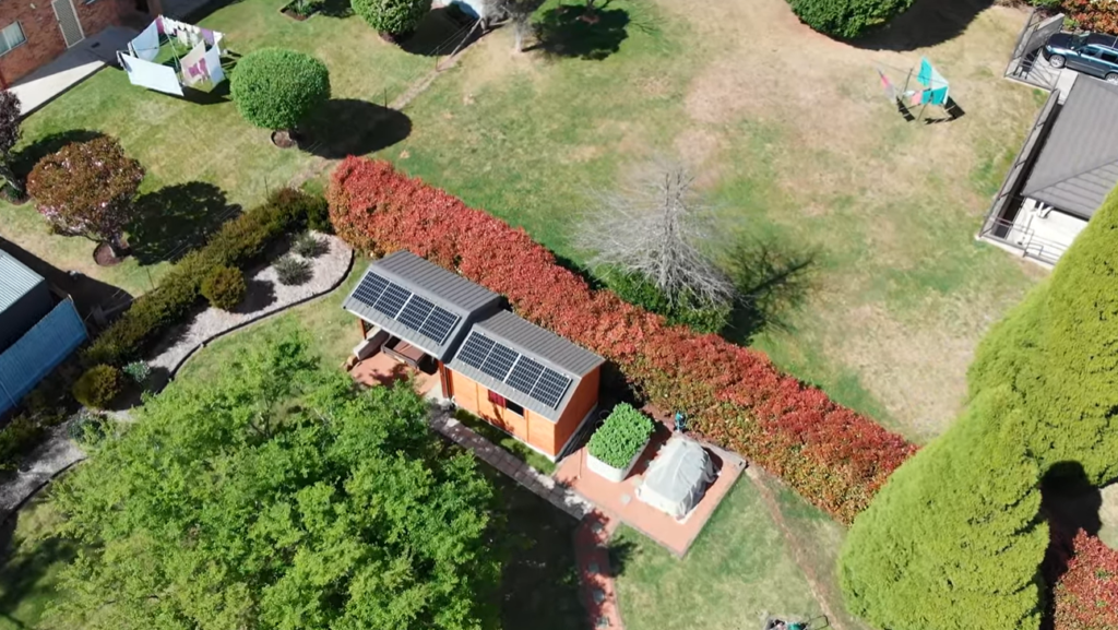 Aerial view of a small backyard building with rooftop solar panels, part of a home solar installation in Moss Vale.