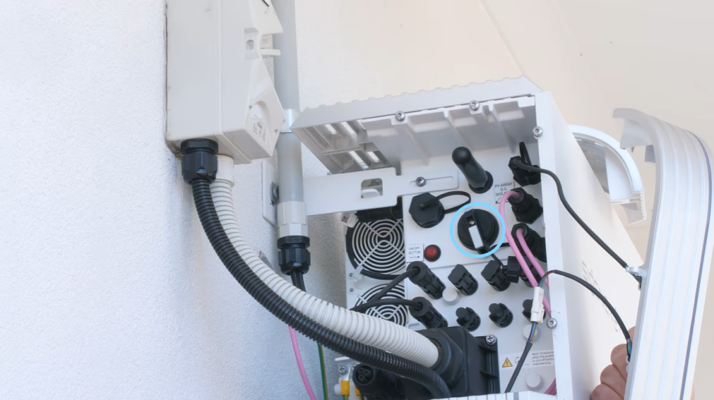 Turning off the PV array DC isolator inside the Sigenergy SigenStor as part of the shutdown procedure.
