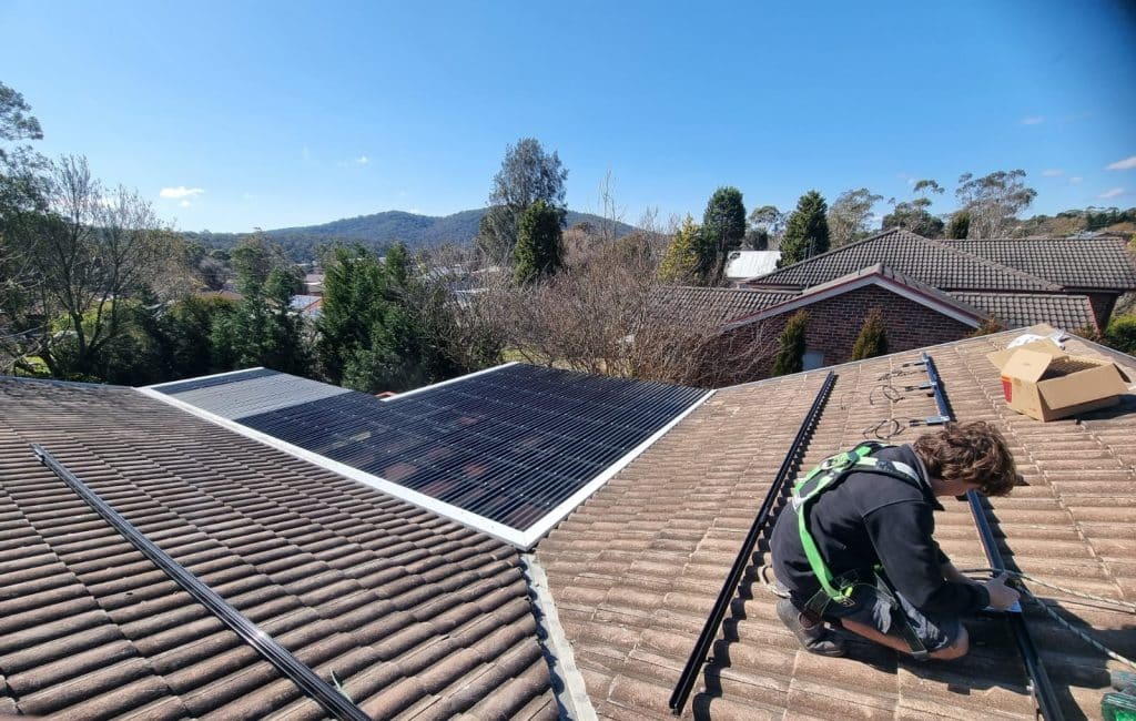 Lenergy staff  members installing solar on tiled roof
