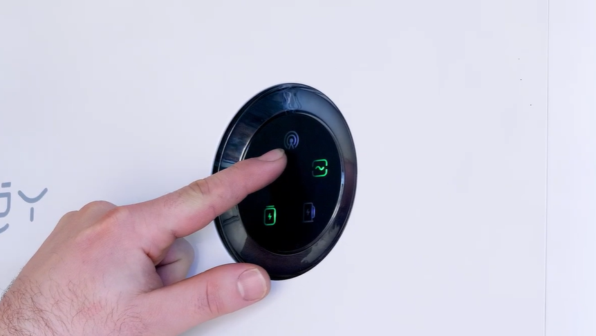 Hand pressing the Wi-Fi indicator on the SigenStor control dial, the top light you check when you reconnect the SigenStor to Wi-Fi.